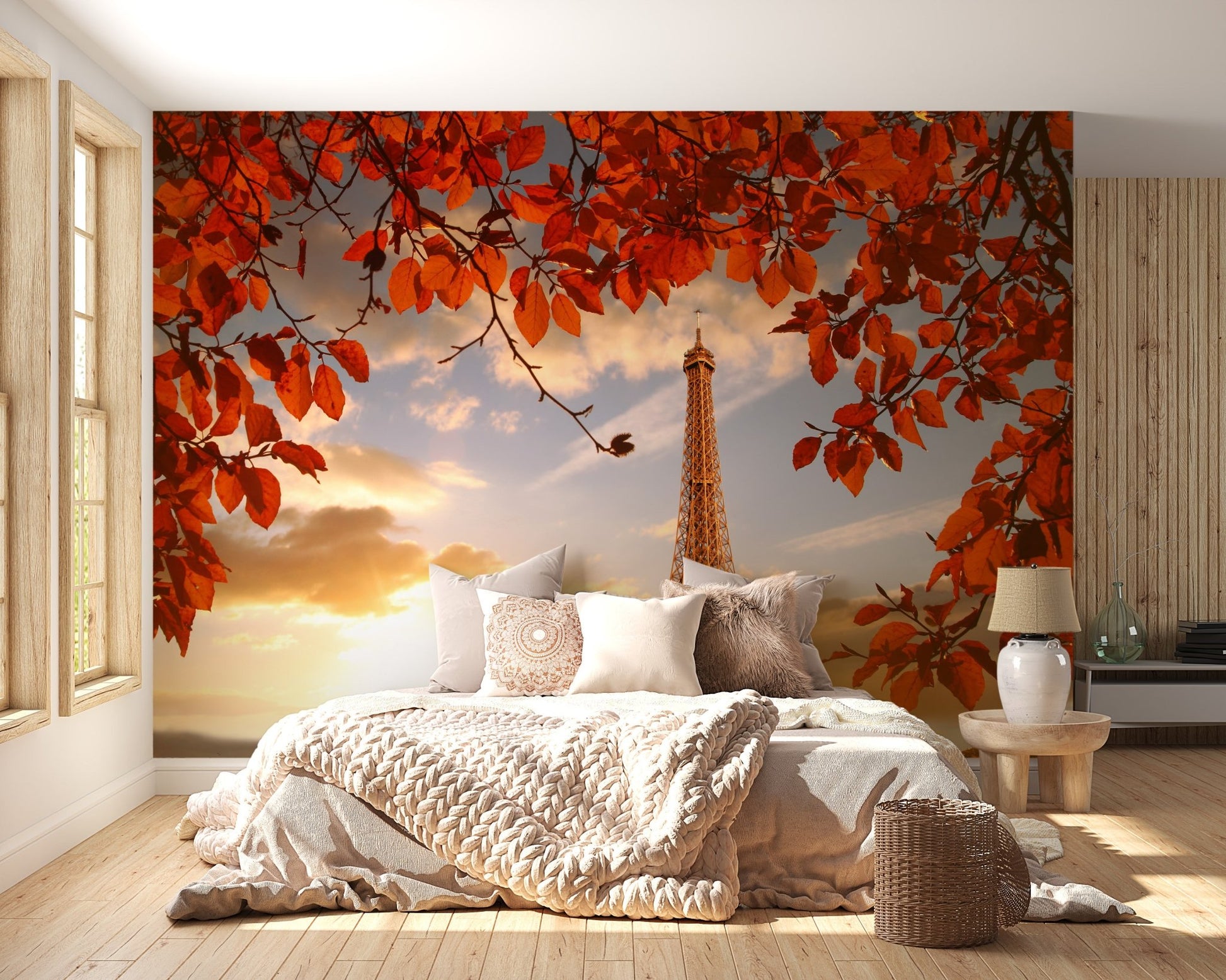 Red autumn foliage wallpaper mural in a warm lit bedroom with beige linens.