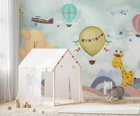 Play area with a small white tent and a cartoon animal wall mural.