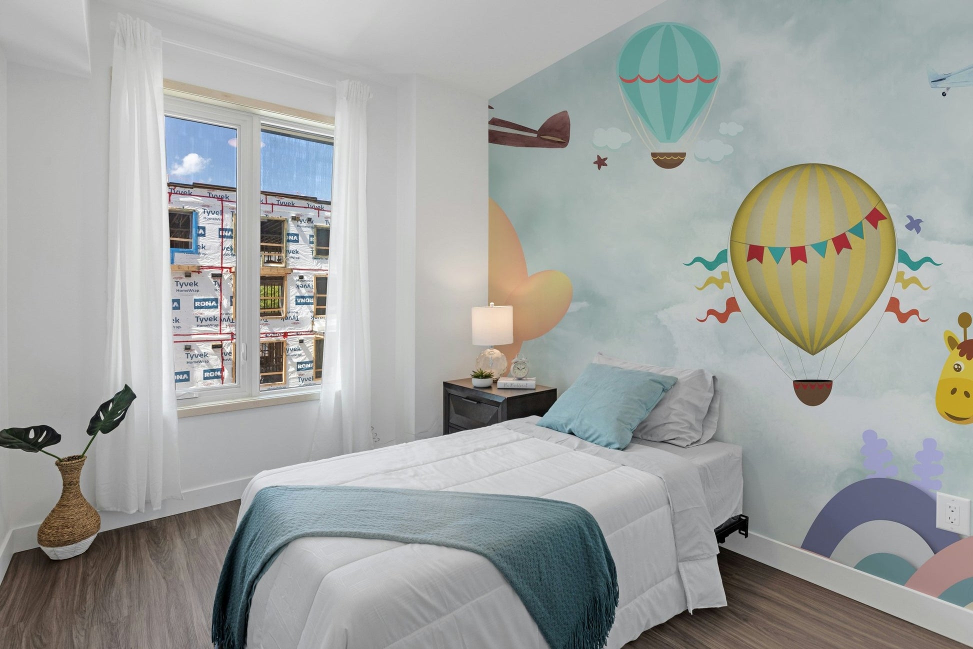 Bedroom wall mural with pastel balloons and small airplanes for a child's space.