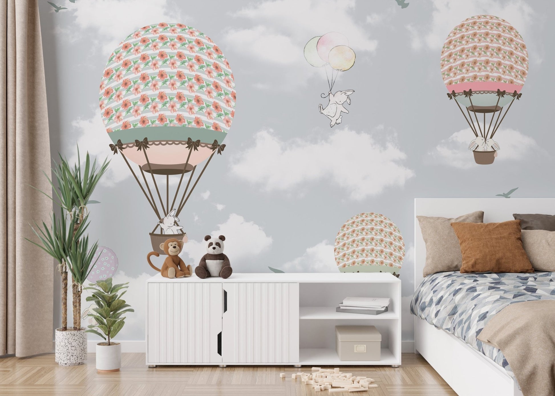 Bedroom wall mural showing bears and rabbits floating in hot air balloons.