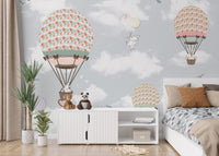 Bedroom wall mural showing bears and rabbits floating in hot air balloons.