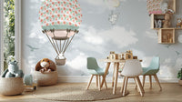 Children’s dining area with mint green chairs and hot air balloon wonderland wall mural.