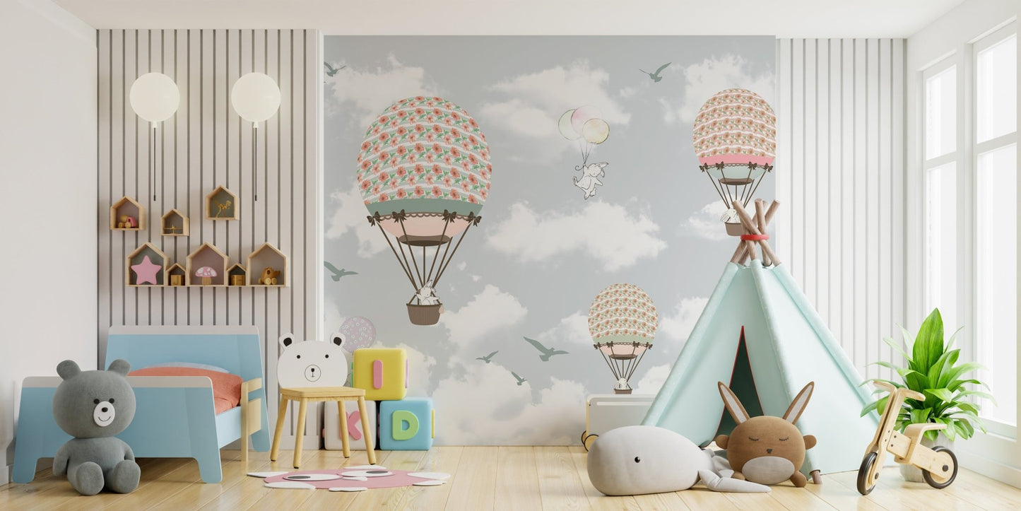 Playful wall mural with animals in balloons for a large open-plan playroom.