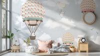 Soft blue sky wall mural with illustrated ballooning in a bright nursery space.