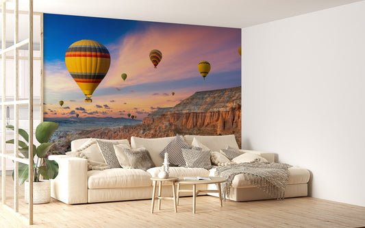 Scenic valley sunset wallpaper mural with floating balloons.