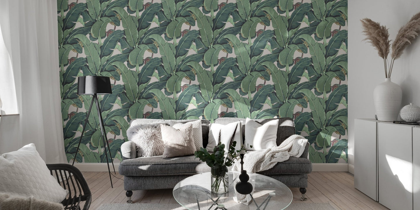 Large green leaf wall mural in a modern living room with a grey sofa.