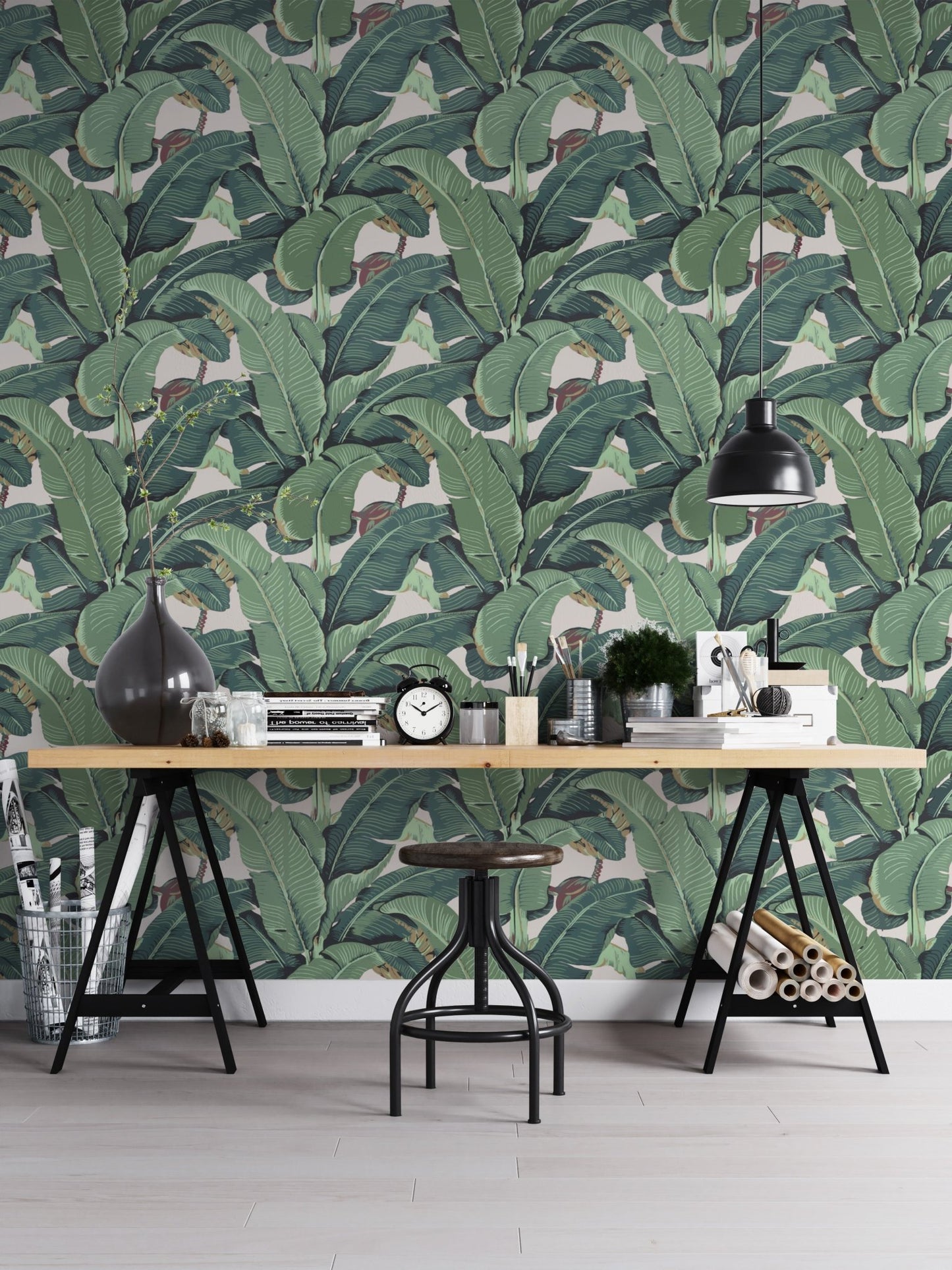 Detailed leaf pattern wall mural behind a black metal desk and stool.