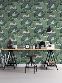 Detailed leaf pattern wall mural behind a black metal desk and stool.