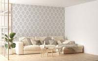 Damask wallpaper design in a spacious living area with a white sofa.