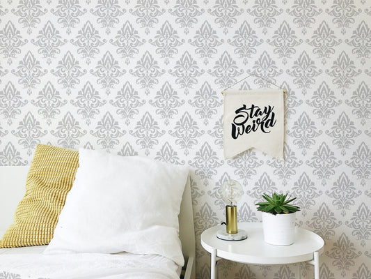 Damask wallpaper with gray baroque pattern in a modern bedroom setting.