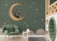 Playroom seating area featuring a green moon wall mural and small armchair.