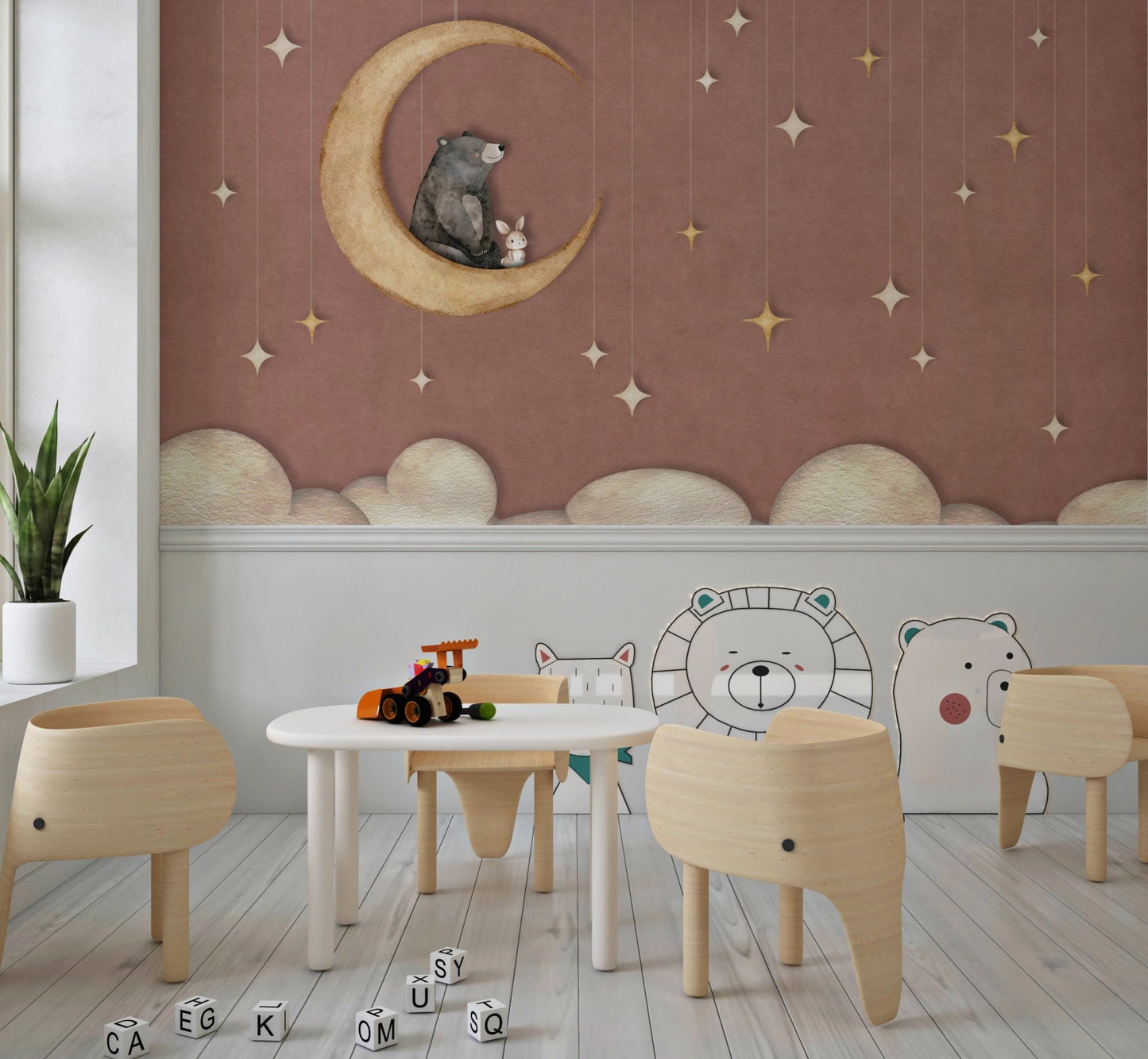 Toddler classroom with small chairs and moon patterned wall mural.