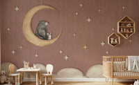 Playroom with a small wooden table set against a red moon wall mural.