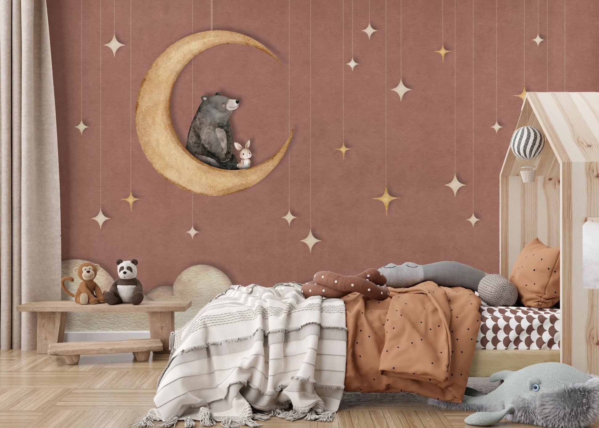 Childrens bedroom featuring a wooden house bed and starry moon wall mural