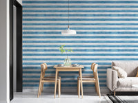 Dining table setup against blue and white watercolor stripe wallpaper.