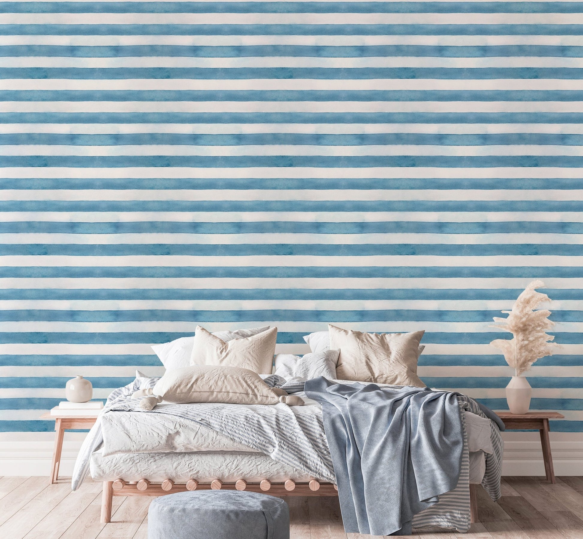 Double bed with textured blue stripe wallpaper and side tables.
