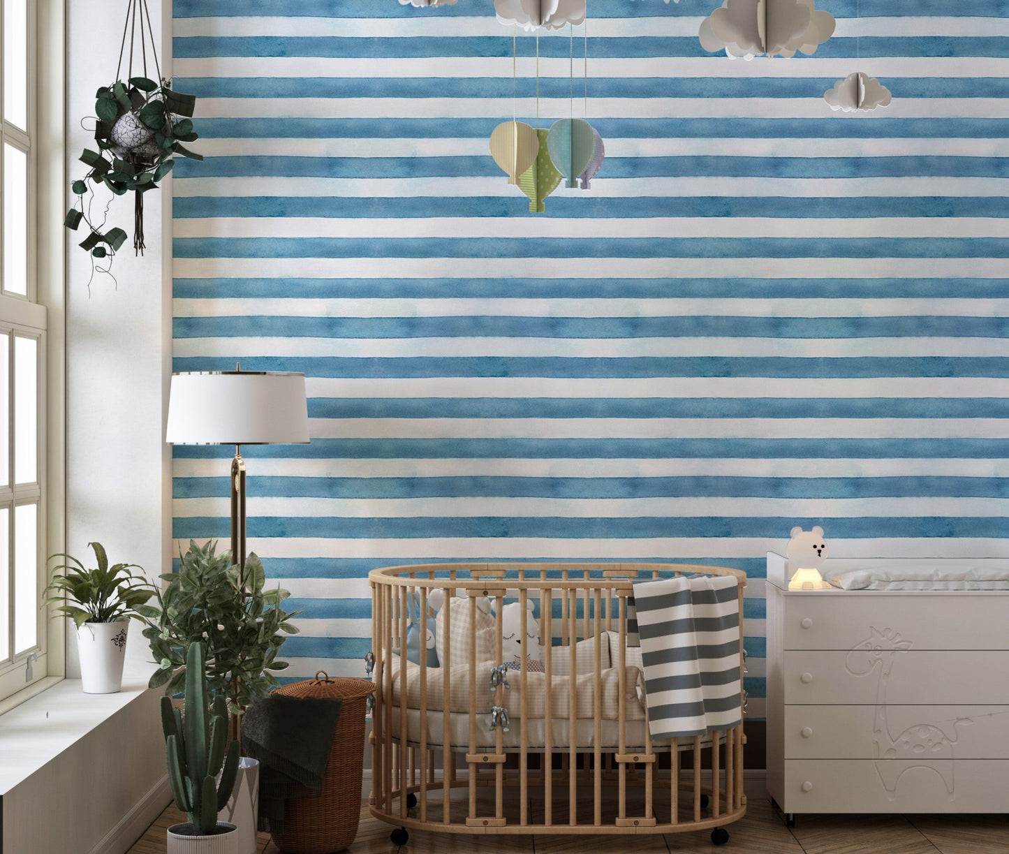 Nursery room featuring blue watercolor stripe wallpaper and crib.