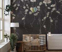 Nursery room with dark black flowers & birds wall mural and wooden crib.