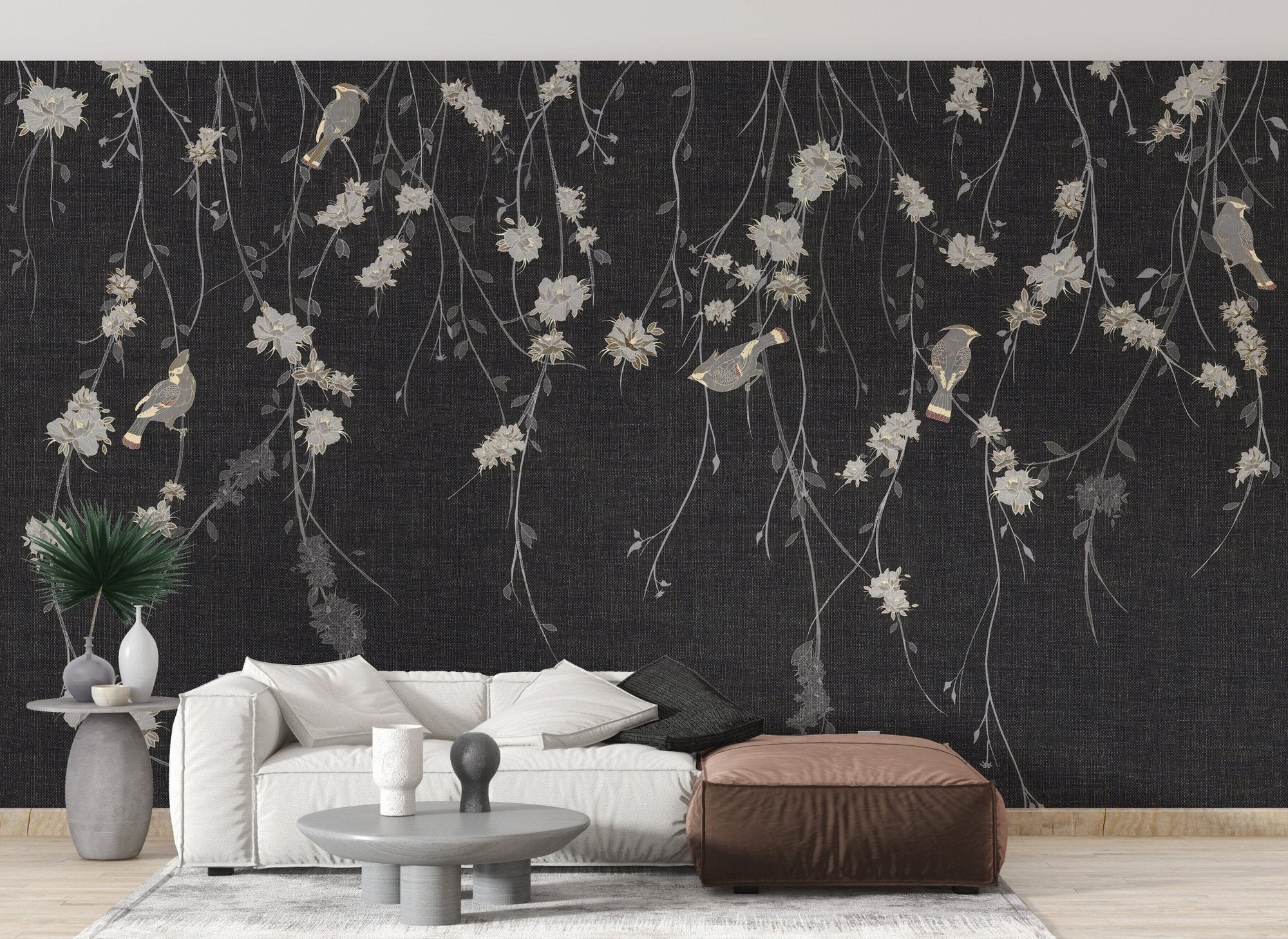 Modern living featuring charcoal floral wall mural and white sectional couch.