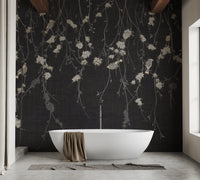 Bathroom wall mural featuring black floral design behind a white pedestal tub.