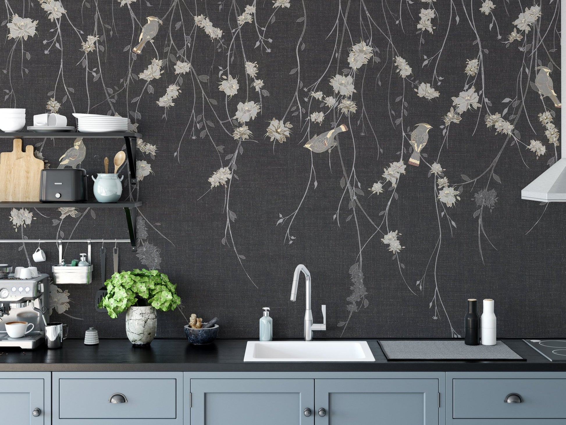 Kitchen interior with dark floral wall mural behind a black countertop and sink.