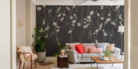 Living room with dark black flowers & birds wall mural and beige sofa.