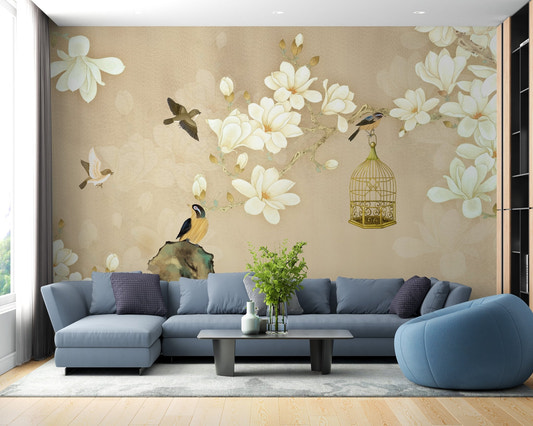 Blue sectional sofa against a floral wall mural with white blossoms and birds.