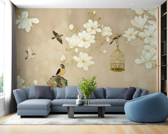 Blue sectional sofa against a floral wall mural with white blossoms and birds.
