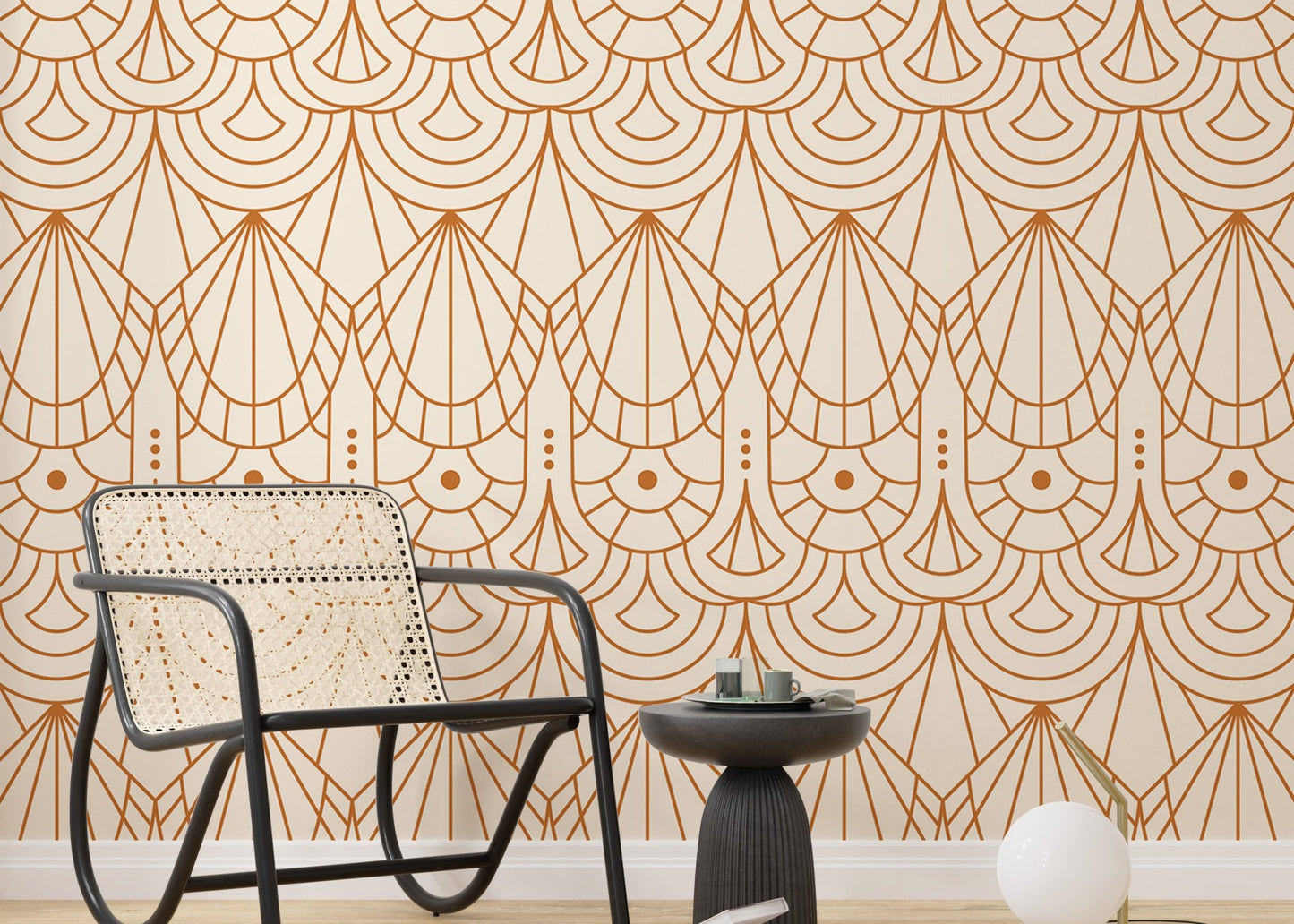 Geometric repeat pattern wallpaper behind a black wicker chair and side table.