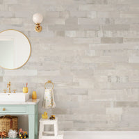 Understated beige faux brick wall mural in a bathroom with mirror.
