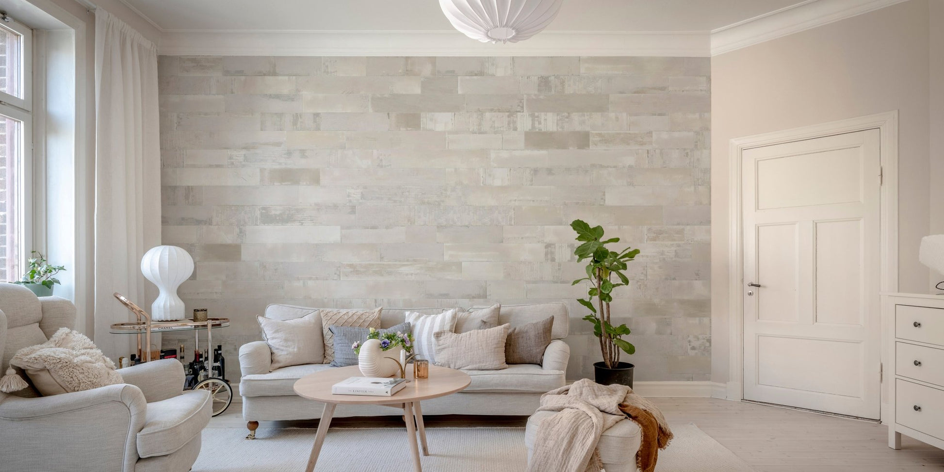 Realistic brickwork wall mural in a living room with a beige sofa.