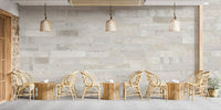 Rustic brick-inspired wall mural in cafe with tables and chairs.