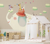 Indoor play house placed in front of a beige animal wall mural in kids area.