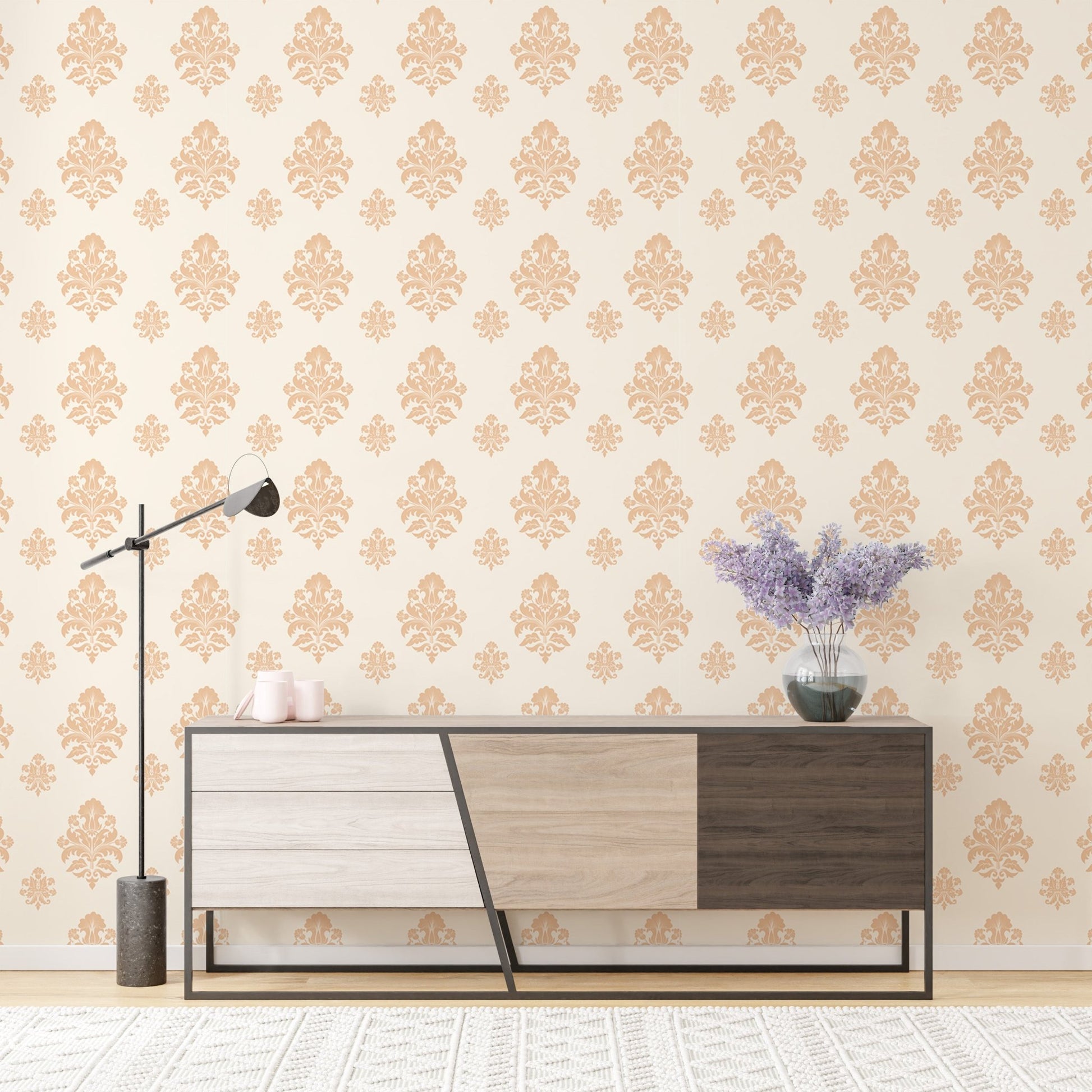 Beige classical damask repeat pattern wallpaper on a wall behind a wooden sideboard.