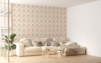 Beige classical damask repeat pattern wallpaper in a living space with a cream sofa.