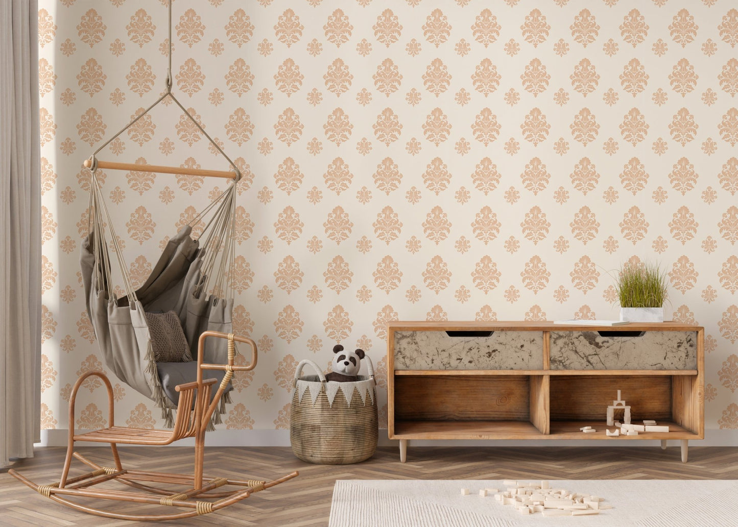Beige classical damask repeat pattern wallpaper behind a wooden console and swing chair in nursery.