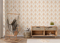 Beige classical damask repeat pattern wallpaper behind a wooden console and swing chair in nursery.