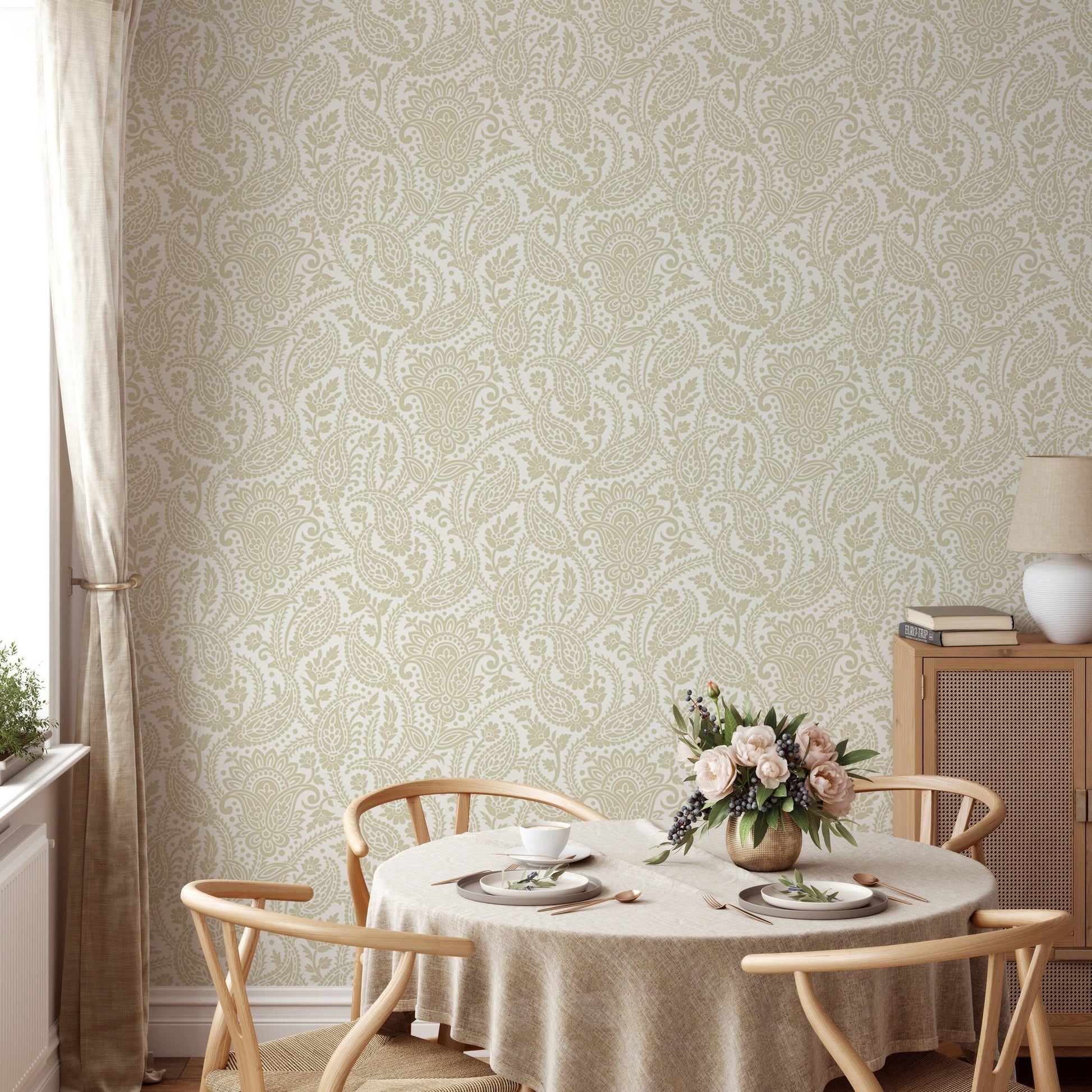 Round dining table set against beige honey paisley print wallpaper