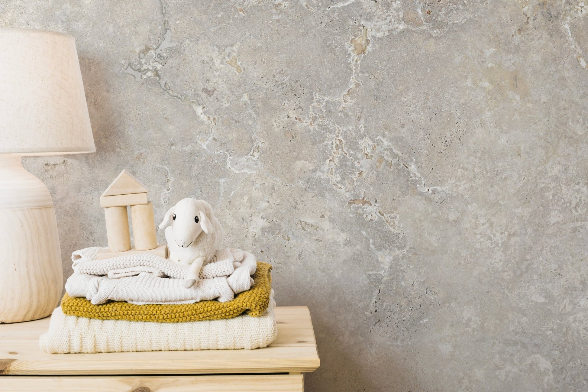 Neutral marble pattern wall mural used as a backdrop for a wooden table.