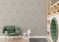 Kids playroom featuring a green chair and beige paisley pattern wallpaper.