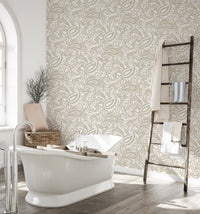 Bathroom interior featuring a standalone tub and paisley pattern wallpaper.