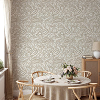 Round dining table set against a full-scale paisley motif wallpaper.