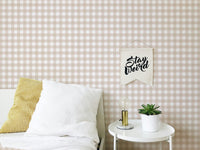 Bedroom wall with white pillows and scozzese shabby stripe wallpaper pattern.