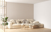 Large lounge with a neutral sofa and beige color scozzese shabby stripe wallpaper.