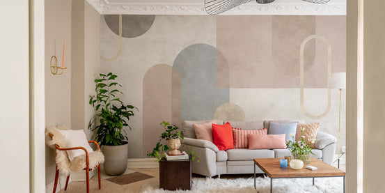 Side view of a textured sepia geometric mural in a bright hallway.
