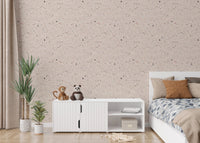 Neutral stone pattern wallpaper for bedroom behind white storage unit.