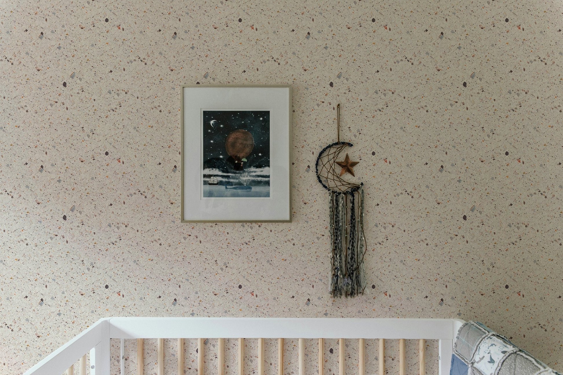 Beige Venetian Quartz Stone Terrazzo Tiles Wallpaper in nursery with wood crib.