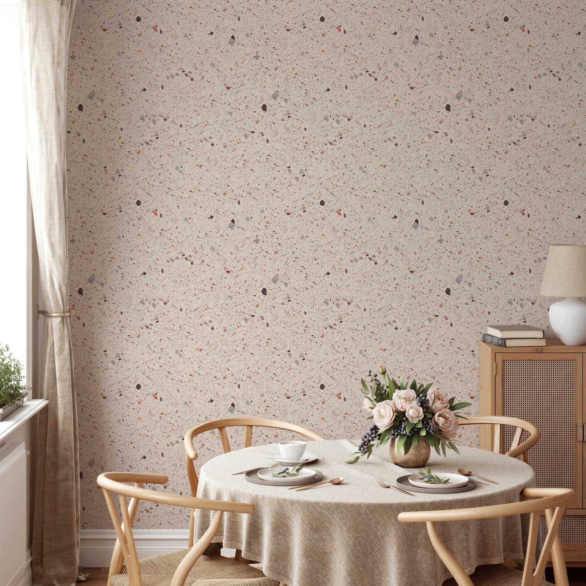 Beige Venetian Quartz Stone Terrazzo Tiles Wallpaper behind round dining table.