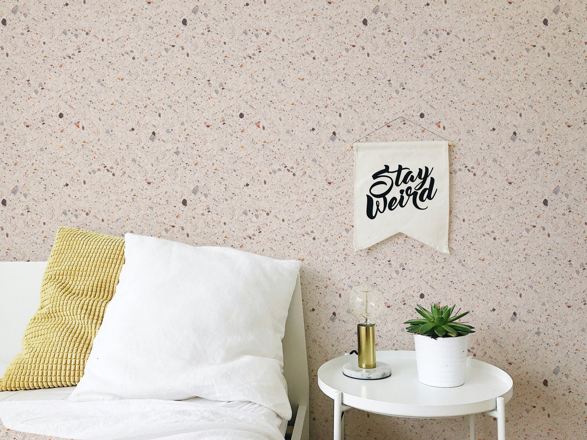 Bedroom stone pattern wallpaper with white bedding and yellow accent pillow