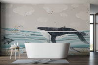 Big whale kids wallpaper mural with white clouds and seagulls in the sky.